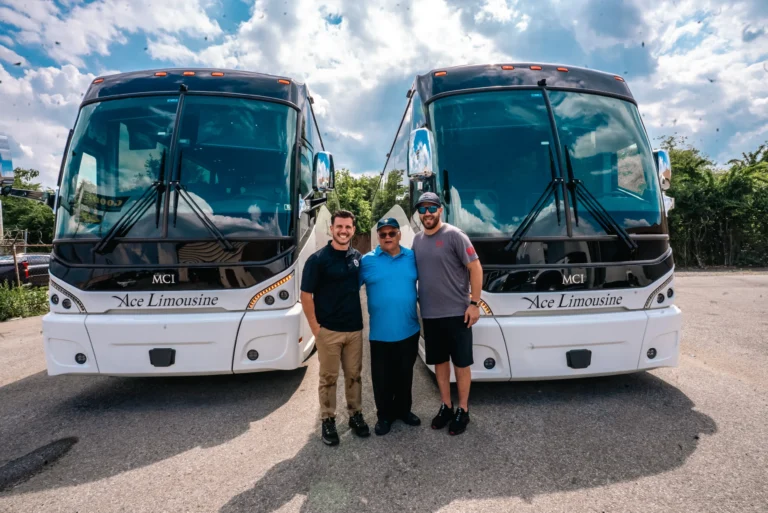 Ace Limousine owners and family standing between two coach buses